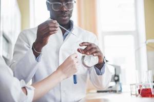 Experiments in the chemical laboratory. An experiment was carried out in a laboratory in transparent flasks photo