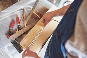 A man works in a joiner's shop, working with a tree. photo