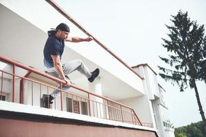 Young sports man doing parkour in the city. photo