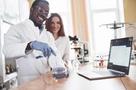 Laboratory laboratories conduct experiments in a chemical laboratory in transparent flasks. Output formulas photo