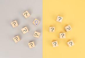 Concept to find idea in problem solving for business.  Wooden cube question mark and light bulb icons photo