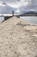 Cement dike in the sea photo