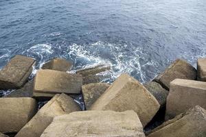 Cement dike in the sea photo