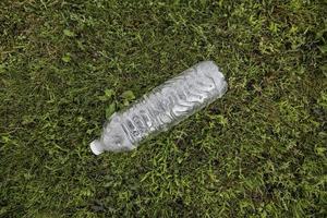 Bottle of water on the grass photo