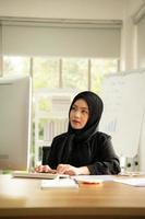 Arabic businesswoman wearing hijab Work in the office photo