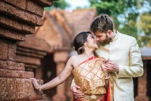 Asian bride and Caucasian groom have romantic time with Thailand dress