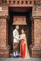 Asian bride and Caucasian groom have romantic time with Thailand dress photo
