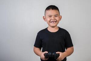 Happy boy play game computer with a controller in studio photo