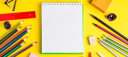 Flat lay of stationery on yellow background. Back to school concept. Place for text. photo