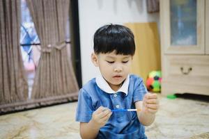Children use watercolor brushes to draw on their arms to create imagination and enhance their learning skills. photo