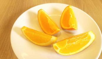 rodajas de naranja colocadas en un plato blanco. foto