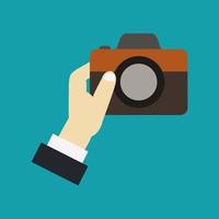 Camera in hand vector