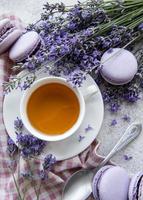 Cup of tea with macaroon dessert with lavender flavor photo