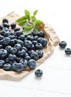 Blueberries on white tile  background photo