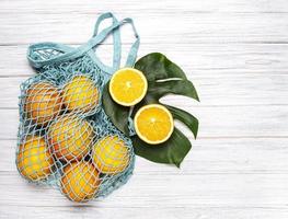 Mesh shopping bag with oranges photo