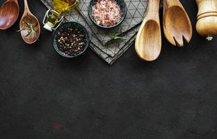 Old wooden kitchen utensils and spices as a border photo