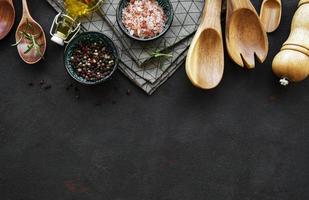 Old wooden kitchen utensils and spices as a border photo
