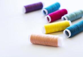 Spools of thread on a white photo