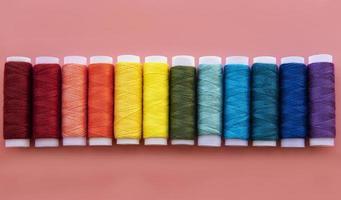 Spools of thread on the colors of the rainbow photo