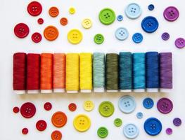 Spools of thread and buttons on the colors  of the rainbows photo