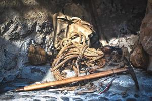 Old ice ax and crampons backpack outside an old alpine hut photo