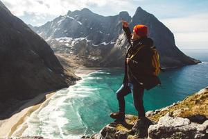 Man stand on cliff edge alone enjoying aerial view backpacking lifestyle travel adventure outdoor vacations photo