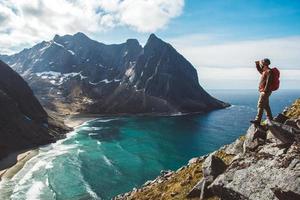 Man stand on cliff edge alone enjoying aerial view photo