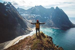 Man stand on cliff edge alone enjoying aerial view backpacking lifestyle travel adventure outdoor vacations photo