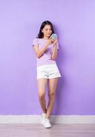 Image of Full body of young asian girl on purple background photo