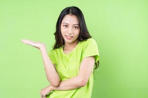 Young Asian woman posing on pink background photo