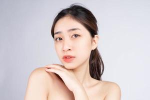 Beautiful young asian woman with clean fresh skin on white background, photo