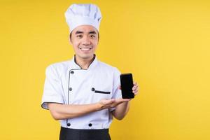 male chef portrait, isolated on yellow background photo