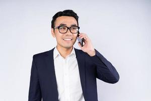 Portrait of business man wearing suit, isolated on white background photo