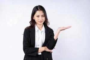 Portrait of young businesswoman wearing a suit, isolated on white background photo