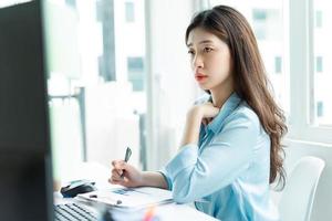 Portrait of young Asian businesswoman at work