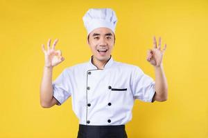 male chef portrait, isolated on yellow background photo
