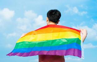 Abstract silhouette of gay man on shoulder is lgbt flag photo