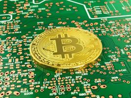 Golden Bitcoin Cryptocurrency on computer circuit board, Printed Circuit Boards, PCB photo