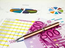 Five hundred 500 Euro bills banknotes with pen, business  background photo