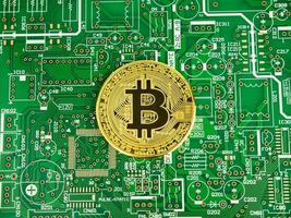 Golden Bitcoin Cryptocurrency on computer circuit board, Printed Circuit Boards, PCB photo