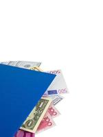 Blue book with nested international banknotes, isolated on white background. Stash of money concept, Business ideas, Clipping path photo