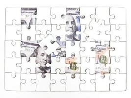 Missing jigsaw puzzle pieces on 100 Dollar money background, Key for Business solution success concept photo