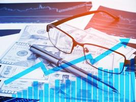 Double exposure Glasses and Pen with business graphs concept of business success