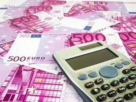 Five hundred 500 Euro bills banknotes with calculator, European currency money background photo