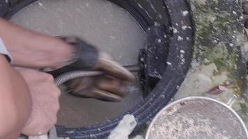 Drain cleaning. Plumber repairing clogged grease trap with auger machine. video