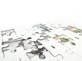 Missing jigsaw puzzle pieces on 100 Dollar money background, Key for Business solution success concept photo