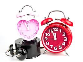 Three alarm clock, red, pink, black isolated on white background photo