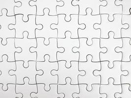 White jigsaw puzzle pieces completed as copy space photo