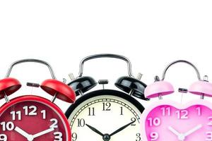 Three alarm clock, red, pink, black isolated on white background photo