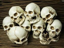 Awesome pile of skull and bone on old wooden background, Still Life style, selective focus, Halloween. photo